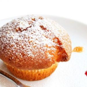 Muffin on a plate isolated on white background